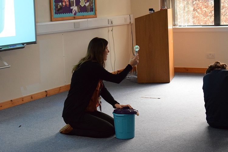 Deborah holding disco ball that lights up on a stick.