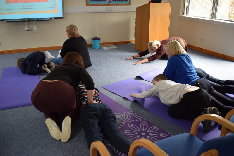 A group of people doing yoga