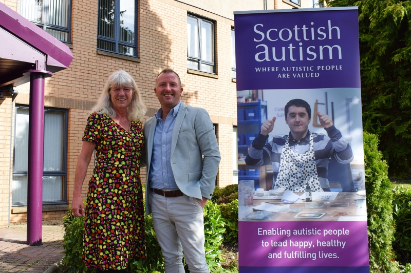 Image is of A-ND CEO, Billy Alexander and Scottish Autism Chief Executive, Dorry McLaughlin outside a building in Alloa, with a Scottish Autism pop up banner to the side