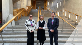 Image is of Scottish Autism team member with Audrey Nicoll MSP in the Scottish Parliament