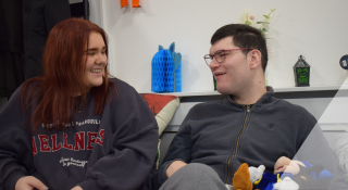 Two people sitting together on a sofa